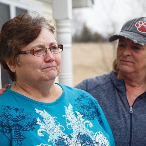 Beth Fry, mother of Amy Sharp, is comforted by...