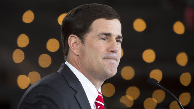0218130520yws PNI Ducey gubernatorial kickoff 2019 - 2.19.14 - State Treasurer Doug Ducey (cq), along with his wife Angela (cq) and 10-year-old son Sam (cq), formally announces his bid as a Republican gubernatorial candidate (cq) at a restaurant in Phoenix (cq) on Wednesday, February 19, 2014 (cq). The creator of Cold Stone Creamery (cq) told an audience of around 50 supporters he wants to eliminate state income tax, revive the economy and improve education. - Charlie Leight/The Arizona Republic