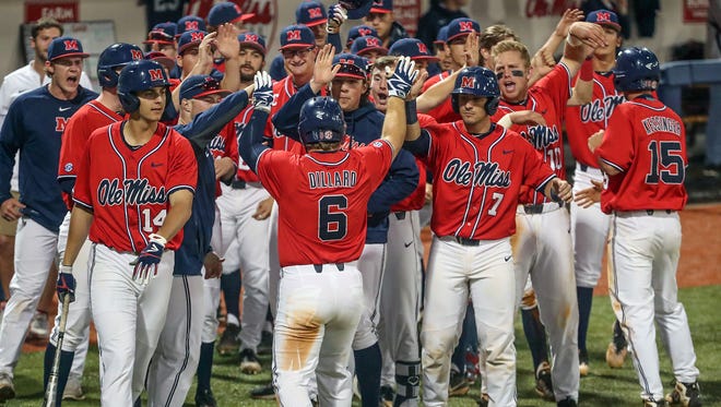 Thomas Dillard (6) celebrates with his teammates after he hit a three-run home run late in Ole Miss' win over USM Tuesday.