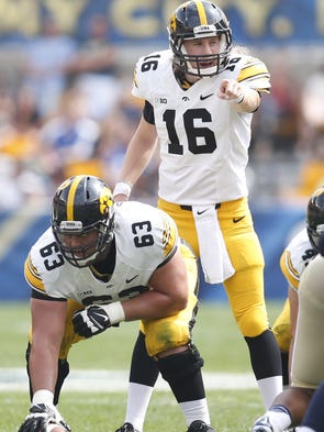 Iowa Hawkeyes quarterback C.J. Beathard (16) gestures while under center Austin Blythe (63) against the Pittsburgh Panthers during the third quarter at Heinz Field. The Hawkeyes won 24-20.