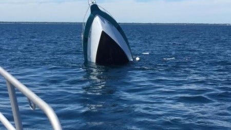 A 31-foot vessel sinks in Lake Michigan about five miles off of Manitowoc, Wis., June 19, 2015. The U.S. Coast Guard rescued four passengers minutes before.