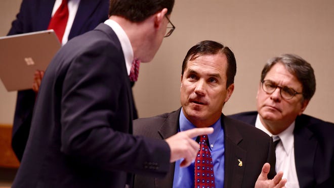 Nick Lyon, center, talks with his attorney John Bursch, left, during the hearing Wednesday.