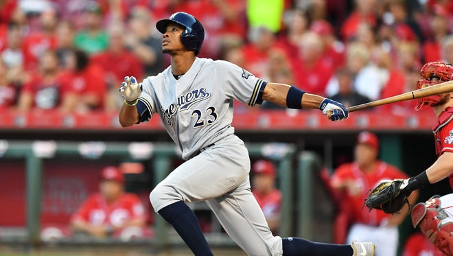 Keon Broxton watches his solo home run in the second inning against the Cincinnati Reds.