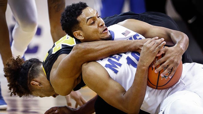 University of Memphis guard Christian Kessee (right) grabs a loose ball away from Iowa University forward Dom Uhl (left)  during first half action of the third place game at the Emerald Coast Classic in Niceville, Florida.