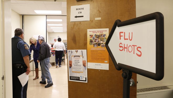 People sign up to receive flu shots at the Rockland County Health Department, Oct. 2, 2015 in Pomona.