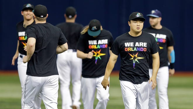 Tampa Bay Rays players wear "We Are Orlando" T-shirts, in memory of the victims of the fatal shooting at the Pulse Orlando night club, as they warm up before a game against the San Francisco Giants.