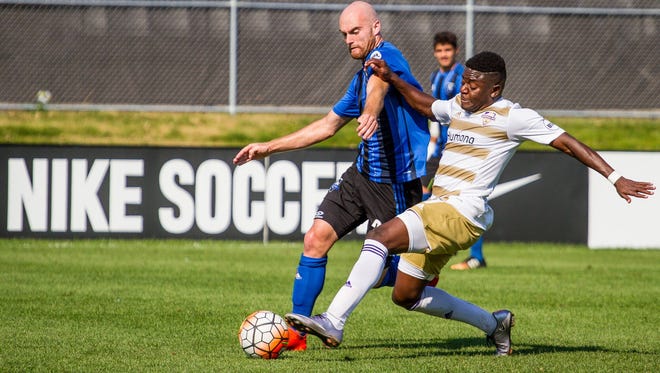 Kadeem Dacres attempts to tackle the ball away from an FC Montreal player