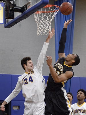 Greece Athena's Israel Dudley, right, shoots over Irondequoit's Jeremiah Zitz during a regular-season game at Irondequoit High School on Wednesday, Feb. 8, 2017.