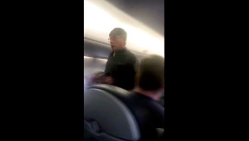 This Sunday, April 9, 2017, image made from a video provided by Audra D. Bridges shows a passenger who was removed from a United Airlines flight in Chicago. Video of police officers dragging the passenger from an overbooked United Airlines flight sparked an uproar Monday on social media, and a spokesman for the airline insisted that employees had no choice but to contact authorities to remove the man.