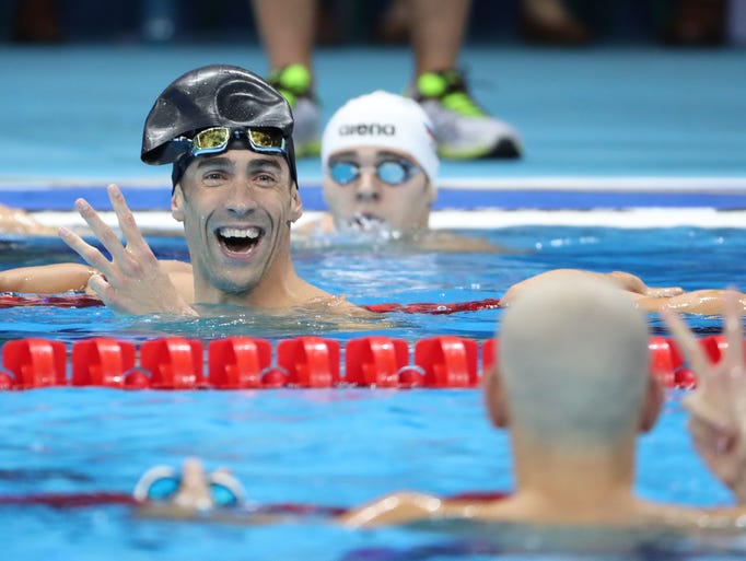 Michael Phelps reacts after finishing in a three-way