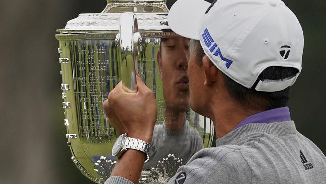 Collin Morikawa kisses the Wanamaker Trophy after winning the PGA Championship golf tournament at TPC Harding Park in San Francisco Sunday.