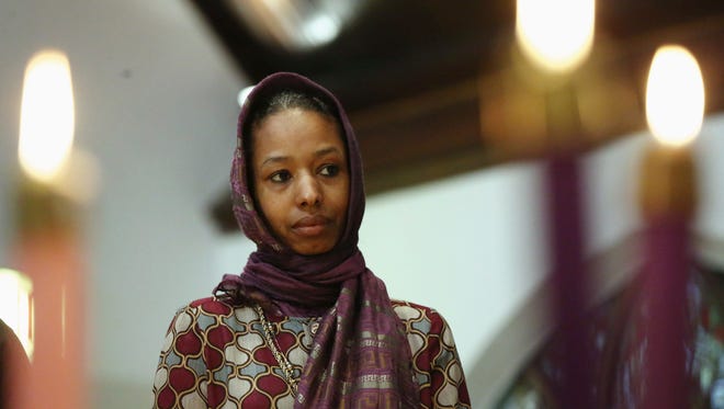 Larycia Hawkins, a Christian, and an associate professor of political science at Wheaton College, a private evangelical school in Wheaton, Ill., wears a hijab at a church service in Chicago. The school said in a statement Tuesday Dec. 16, 2015, it has Hawkins placed on administrative leave because of statements she made on social media about similarities between Islam and Christianity.
