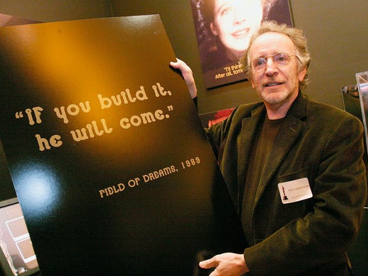 Screenwriter Phil Alden Robinson poses beside a poster that bears a famous line from his film "Field Of Dreams" at a cocktail reception honoring the screenwriters featured in the 79th Academy Awards marketing campaign at the "Meet the Oscars" exhibition space at the Hollywood & Highland complex on February 13, 2007.