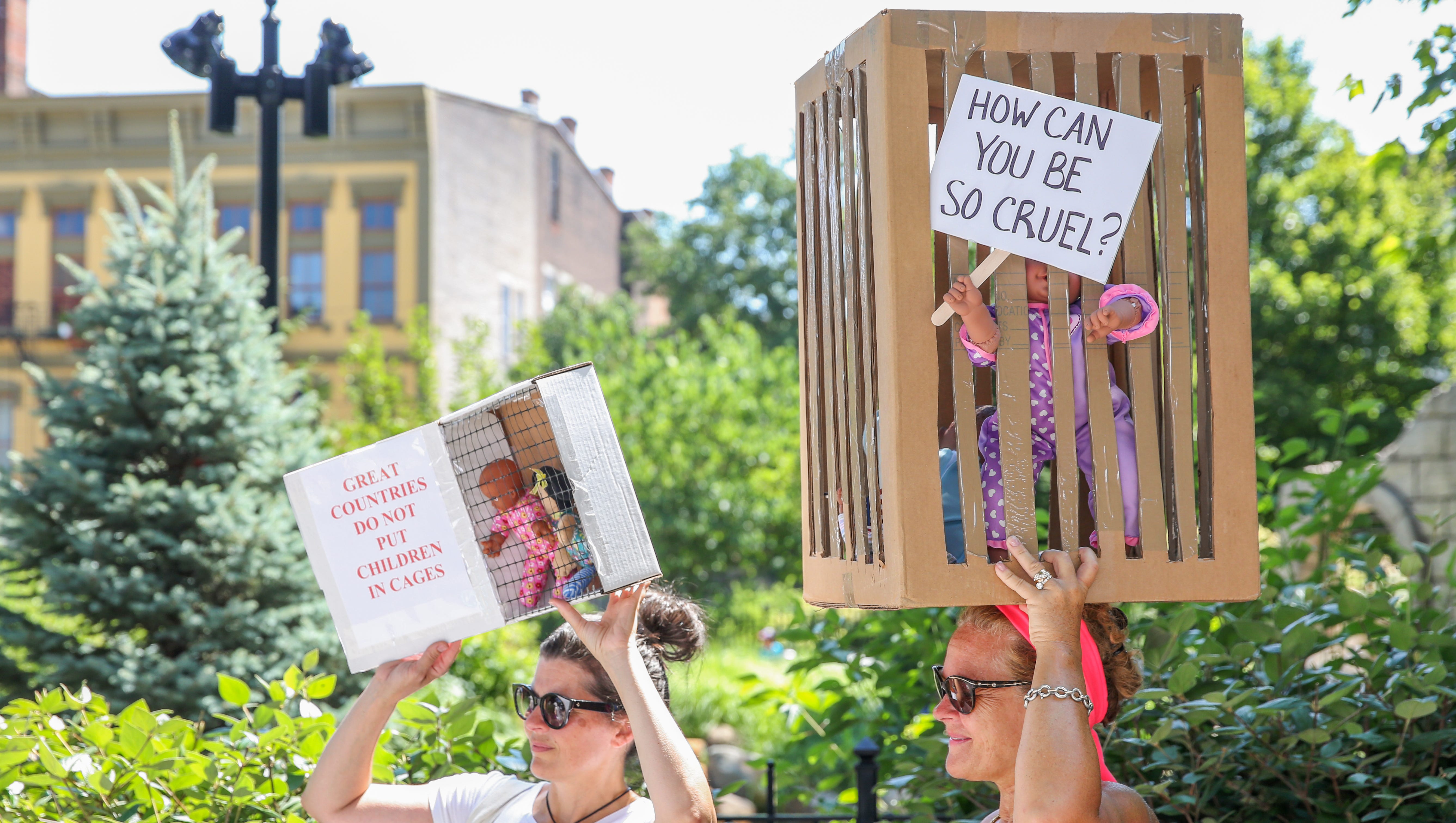 Brynn Fosset and Lisa Hall hold up displays and signs