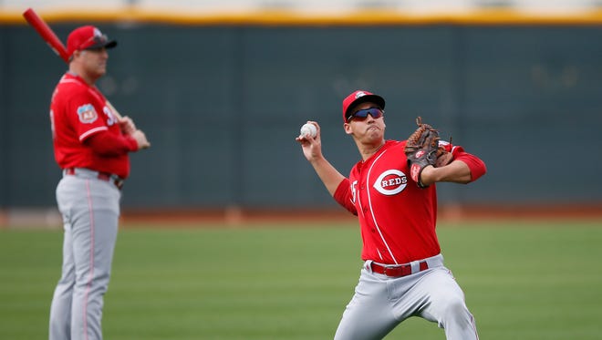 Cincinnati Reds pitcher Robert Stephenson (55), right, long tosses as Cincinnati Reds manager Bryan Price (38), background, observes the pitchers at Cincinnati Reds spring training, Friday, Feb. 19, 2016, in Goodyear, Arizona.
