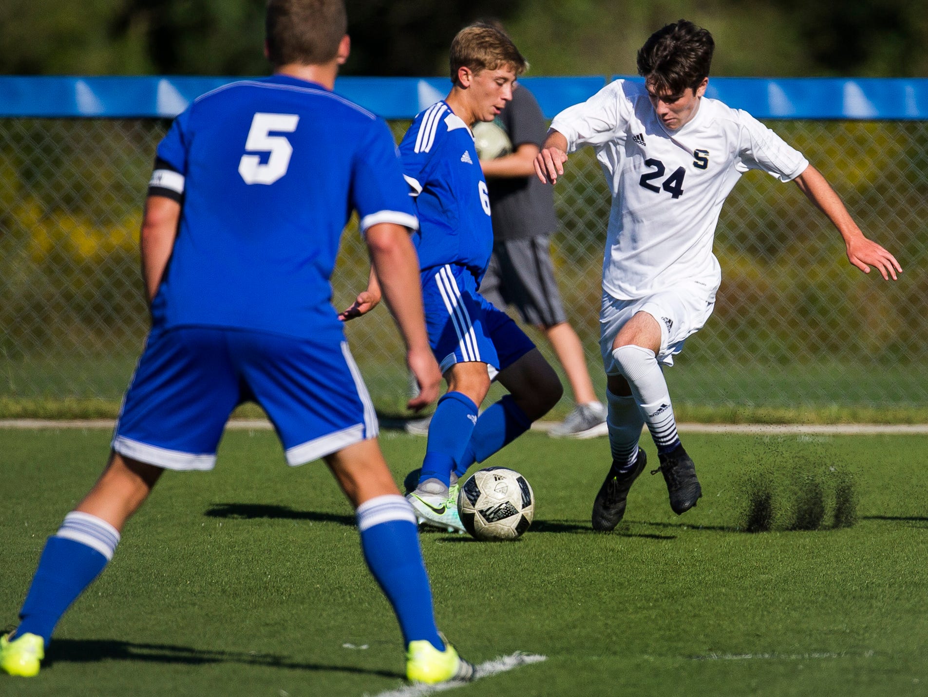 Salesianum's John Leonard (No. 24) tries to work past Wilmington Charter's Anthony Barbieri (No. 6) in the first half of Salesianum's 1-0 win over Wilmington Charter at the Hockessin Soccer Club in Hockessin on Thursday afternoon.