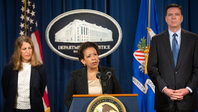 Attorney General Loretta Lynch, center, with Health and Human Service Secretary Sylvia Burwell, left, and FBI Director James Comey, speaks during a news conference at the Justice Department in Washington, Thursday, June 18, 2015. The government says 243 people have been charged in health care fraud sweeps around the country.