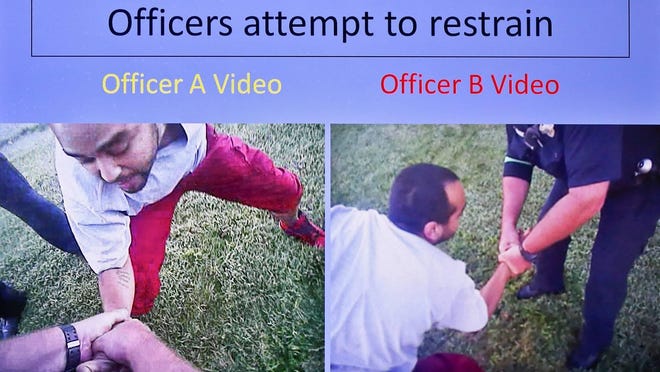 This image taken from Topeka police body camera video shows Dominique White struggling with Topeka police officers in September 2017 before they fatally shot him.