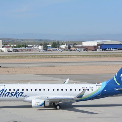 A regional jet in the Alaska Airlines livery parke