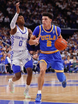 Lonzo Ball dribbles the ball against De'Aaron Fox in the first half at Rupp Arena.