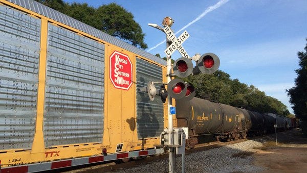 A Cantonment man suffered minor injuries after his truck ran a train stop and collided with an oncoming train on Monday.