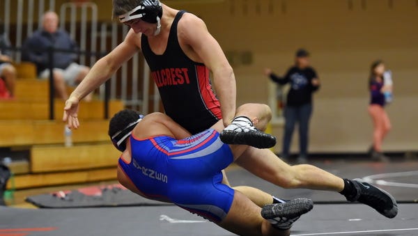 Hillcrest 170-pounder Nick Moore, top, wrestles Donovan Peake of Byrnes during the teams' Class AAAAA second-round playoff match Saturday. Moore pinned Peake, and Hillcrest won 56-18.