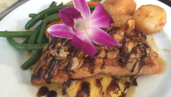 Fernando's Dockside Grille's Salmon Madeira was grilled, flaky filet  smothered with sweet honeyed almonds over a thick slice of grilled pineapple complete with a tangy Madeira wine balsamic reduction drizzle.
