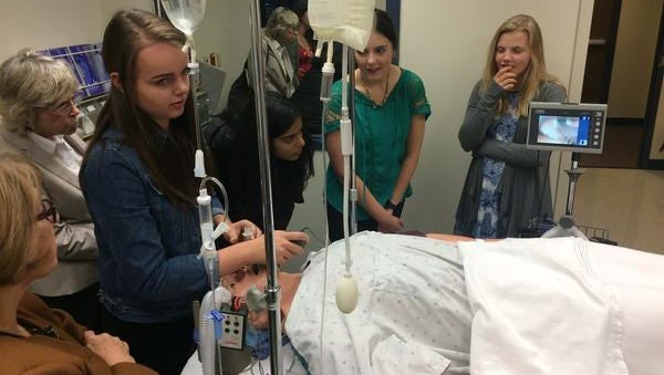 Menomonee Falls High School students taking classes in the school's healthcare academy try out a video assisted Intubation process on a patient simulator at Medical College of Wisconsin. It's one of many opportunities offered to students participating in the program.