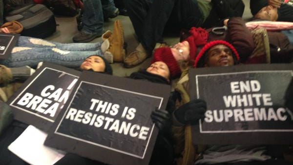 Demonstrators stage a "die in" on Friday at the Apple store on Fifth Avenue in New York.