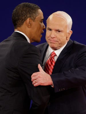 Democratic presidential candidate Sen. Barack Obama (left), D-Ill., and Republican presidential candidate Sen. John McCain, R-Ariz., embrace at the finish of their town hall-style presidential debate at Belmont University in Nashville, Tennessee, on Oct. 7, 2008.