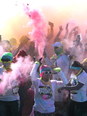 Color Run participants throw colored powder into the air at the conclusion of the run Sunday at Ascarate Park. The "Happiest 5K on the Plant" is part of The Color Run Tropicolor World Tour 2016. Runners wore white and were bathed in an array of colors as they crossed the finish line. The run was a benefit for the Children's Grief Center of El Paso.
