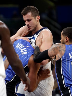 Orlando Magic's Arron Afflalo, left, gets into a fight with Minnesota Timberwolves' Nemanja Bjelica, center, as D.J. Augustin, right, comes in to help break it up during the first half of an NBA basketball game, Tuesday, Jan. 16, 2018, in Orlando, Fla. Afflalo and Bjelica were ejected from the game.