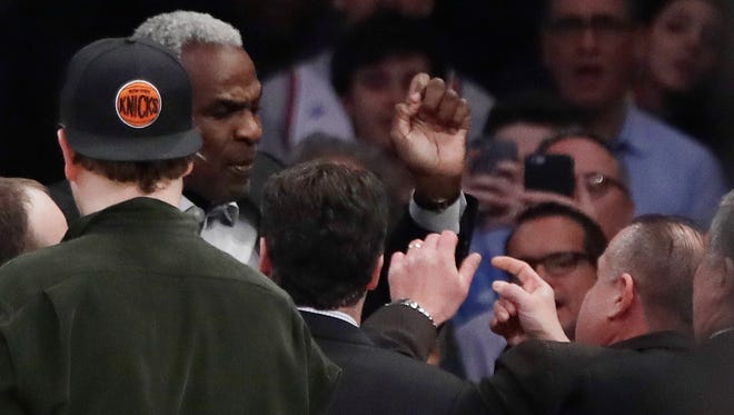 Former New York Knicks player Charles Oakley exchanges words with security guards during the Knicks game on Wednesday.