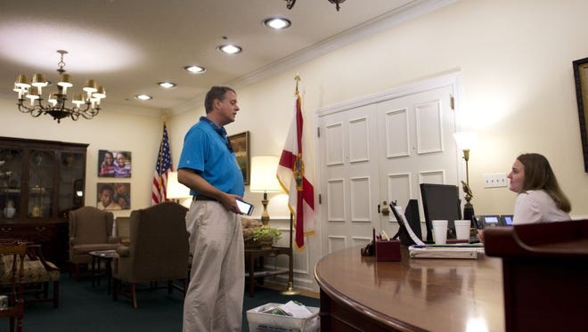 After exchanging emails with Gov. Scott's office for several weeks asking for a meeting, receptionist Erin Kraeft (right) was unable to allow Treasure Coast Newspapers columnist Gil Smart (left) to meet with the governor on Aug. 10, 2016. Janice Johnson (not pictured), consumer service analyst, collected the letters in place of Gov. Scott.