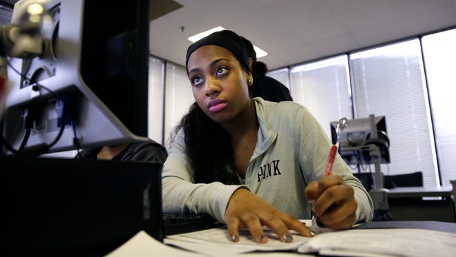 In this Friday, March 10, 2017, file photo, jobseeker Kiana Cupit works on her resume during a resumes writing class at the Texas Workforce Solutions office in Dallas. On Friday, May 19, 2017, the Labor Department reports on state unemployment rates for April. (AP Photo/LM Otero, File)