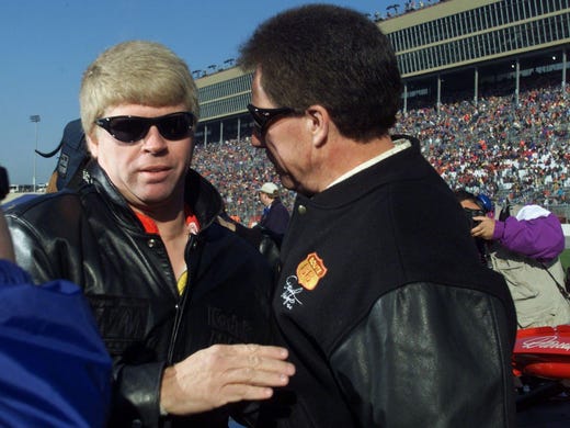 Darrell Waltrip, right, is given a good luck hug and