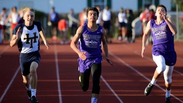 Shane Tripp of Space Coast (center) outruns the field in the 110 during Friday's track meet in Melbourne. 