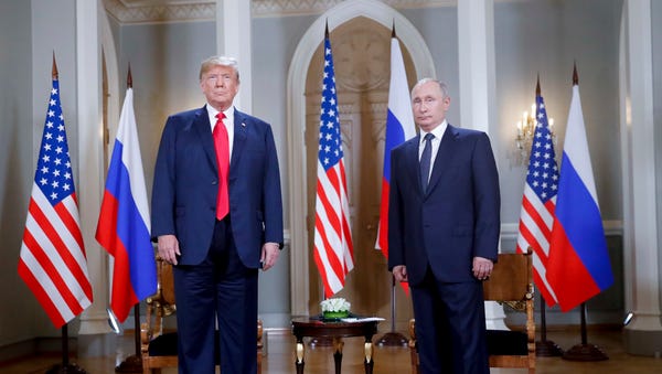 Presidents Donald Trump and Vladimir Putin in...
