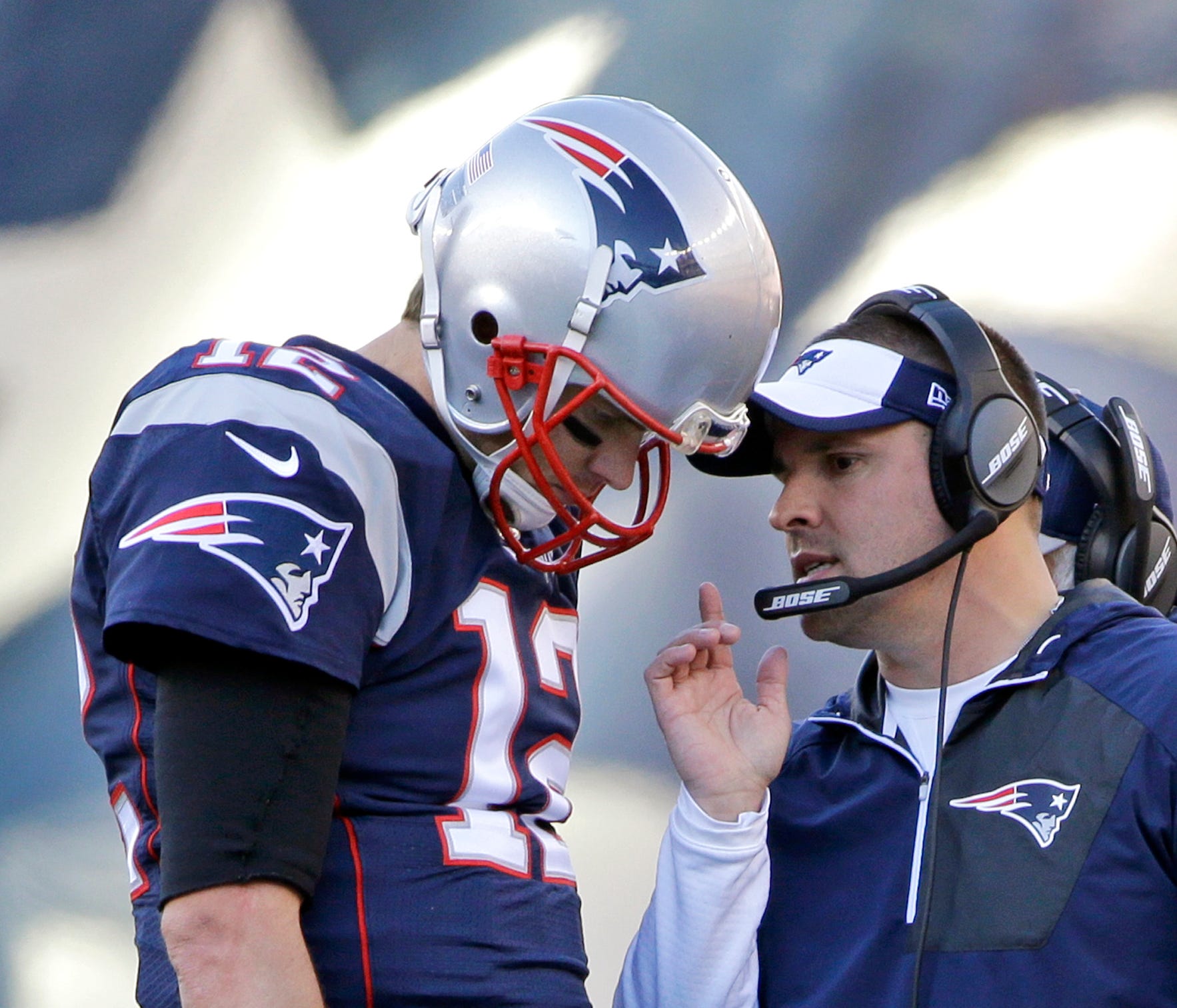 FILE - In this Dec. 4, 2016, file photo, New England Patriots quarterback Tom Brady (12) confers with offensive coordinator Josh McDaniels during the first half of an NFL football game against the Los Angeles Rams, in Foxborough, Mass. Patriots coord