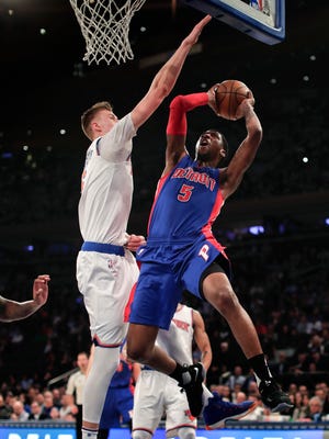Pistons guard Kentavious Caldwell-Pope (5) goes up for a shot against Knicks forward Kristaps Porzingis (6) during the first quarter Monday in New York.