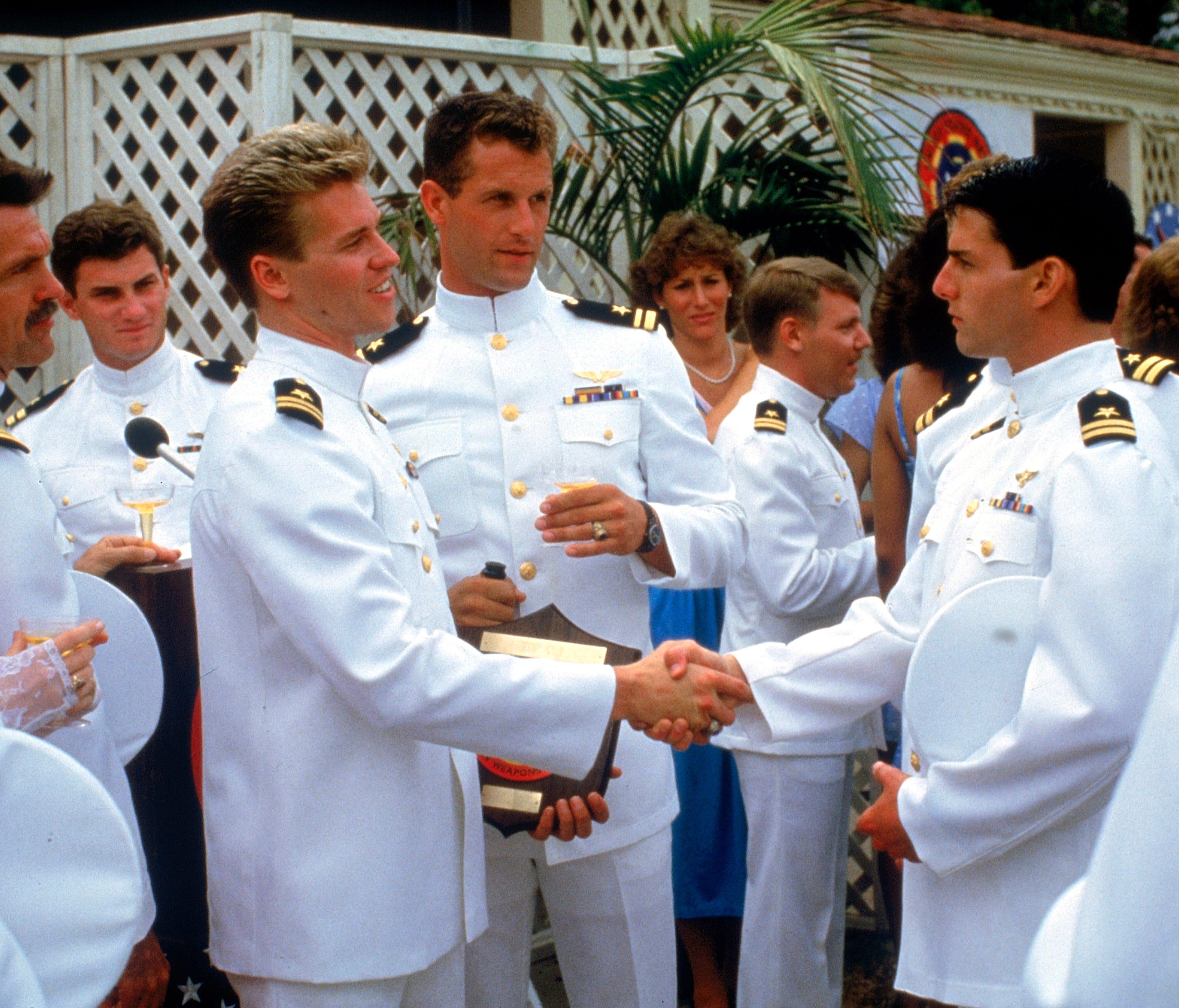 Val Kilmer, left, shakes hands with Tom Cruise in 'Top Gun.'
