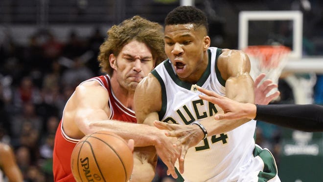 Giannis Antetokounmpo (right) and Bulls center Robin Lopez reach for a loose ball in the first quarter at the BMO Harris Bradley Center on Sunday.