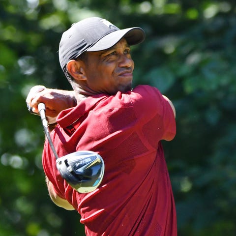 Tiger Woods hits his tee shot on the 9th hole duri