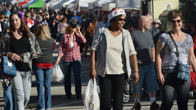 People enjoy the Ventura Winter Wine Walk & Holiday Street Fair in downtown Ventura two years ago.