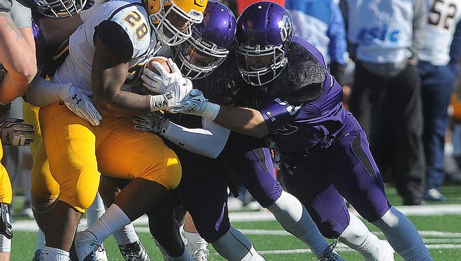 A swarm of University of Sioux Falls defenders take down Augustana University's CJ Ham during their game at Bob Young Field on Saturday, Oct. 24, 2015.