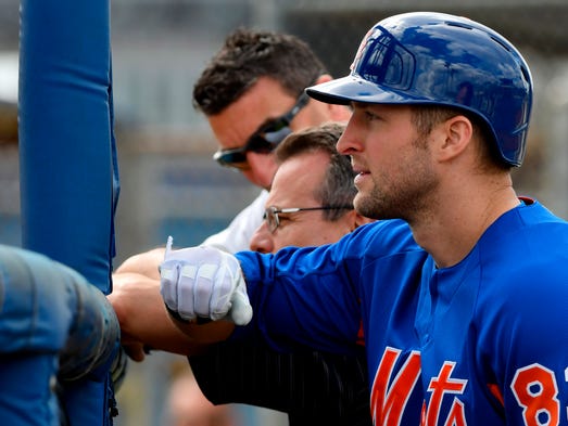 Feb. 19: Tim Tebow  looks on from the batting cage,