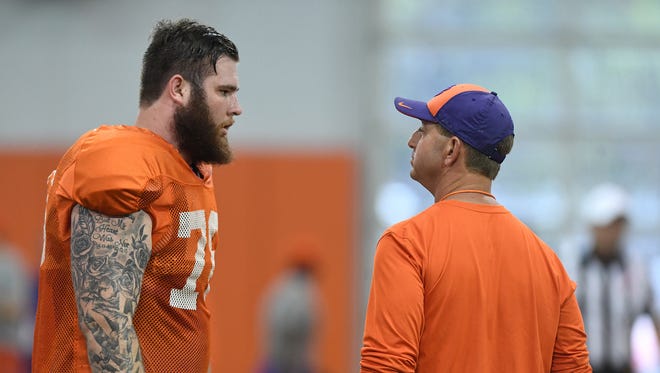 Clemson head coach Dabo Swinney talks with offensive lineman Sean Pollard (76) during the Tigers spring practice on Monday, April 3, 2017.