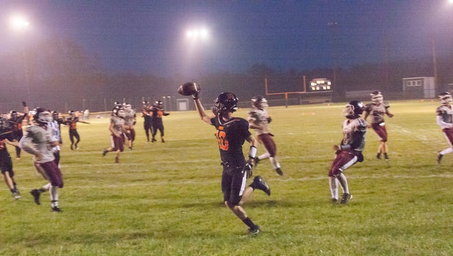 Homer Senior, Joe Roth, holds the ball up after his touchdown Friday night.