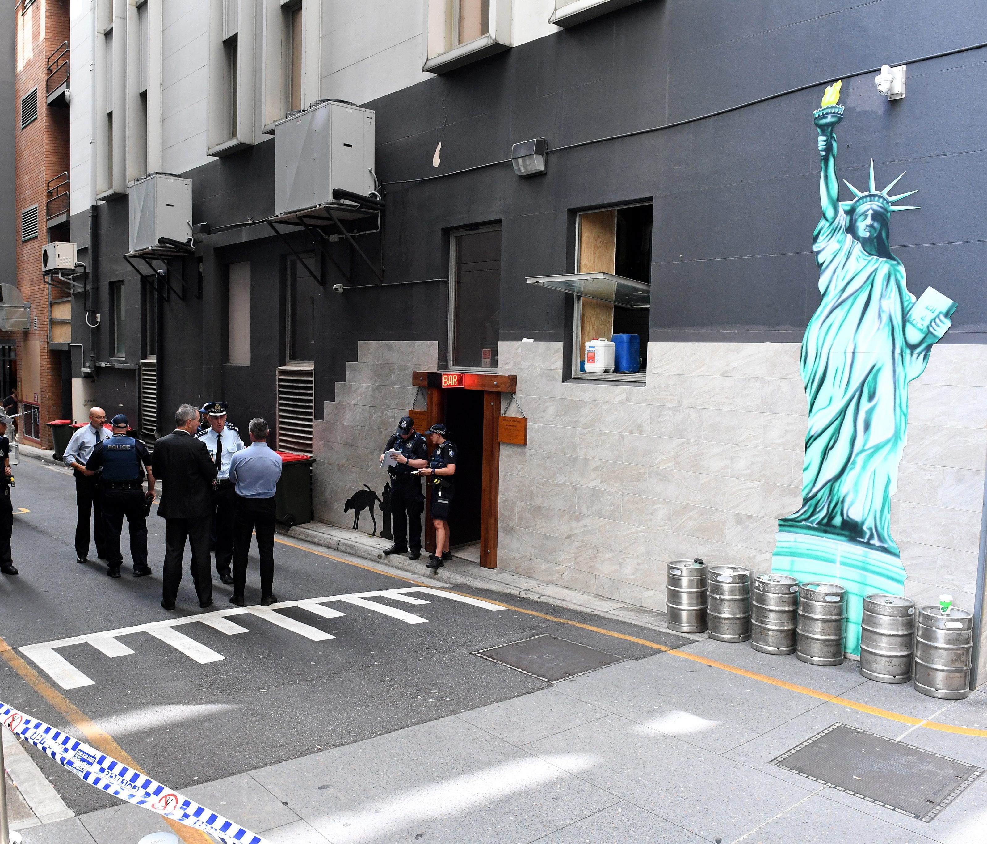 Police officers are seen at a cordoned off area after a man was accidentally shot in Eagle Lane in Brisbane's central business district, Queensland, Australia, Jan. 23, 2017.