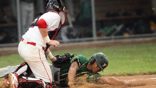 City High’s Brett McCleary tags out West High’s Mason Carter at home plate during their game at Mercer Park on Monday.